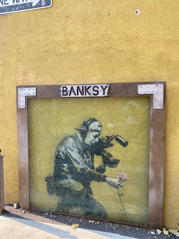 Banksy Graffiti Camera Man And Flower - Image 1