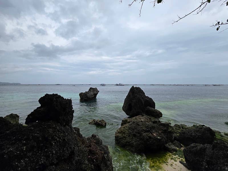 Rocks on white beach path - Image 1